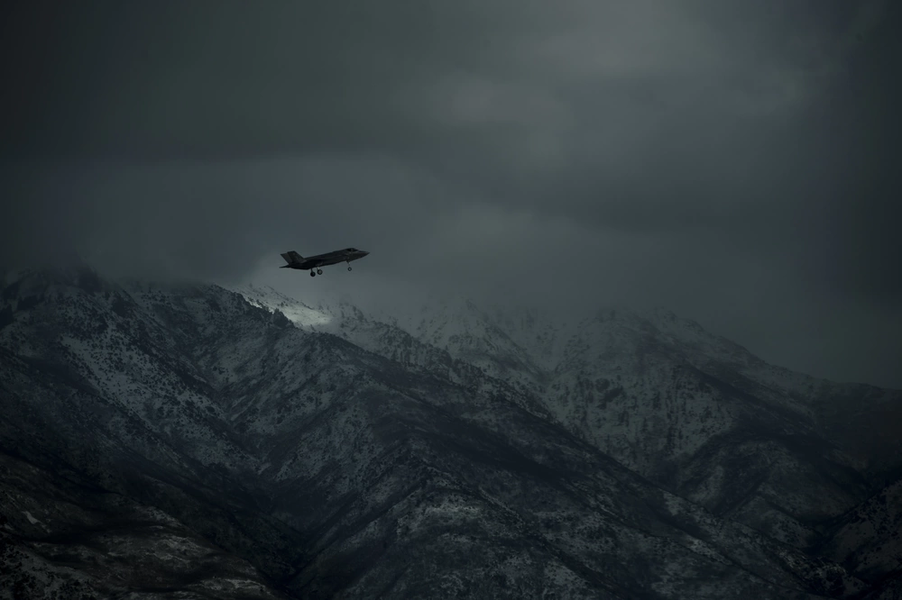 F-35A flying past the snow-covered Wasatch Mountains near Hill Air Force Base in December 2016