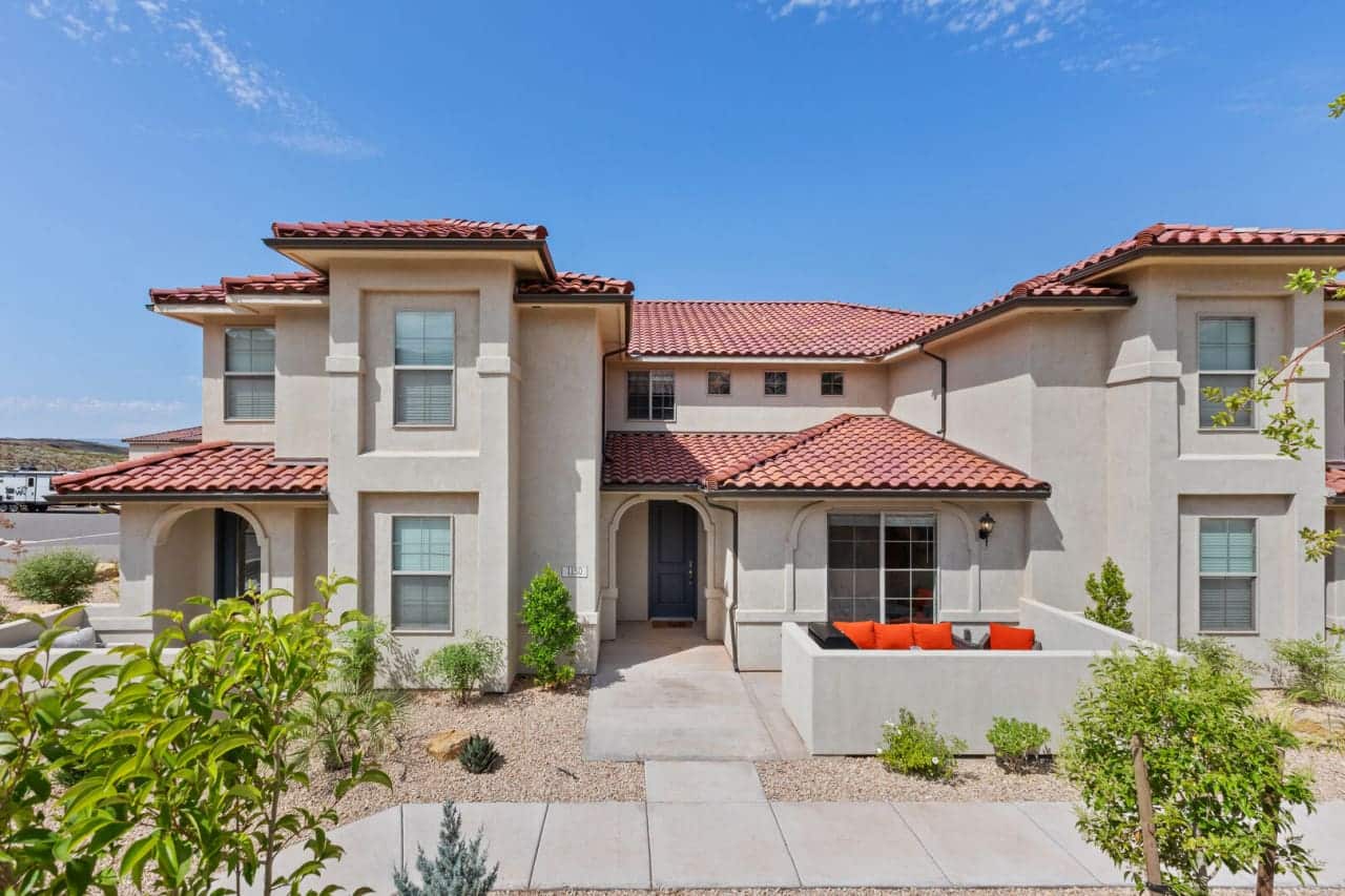 Townhome with red tile roofs and a front patio at Escondido at Sienna Hills in Washington, Utah
