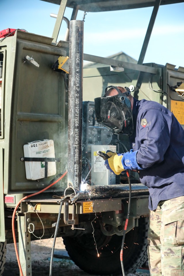 Utah National Guard Forward Support Company soldier welds a road gate at Dinosaur National Monument