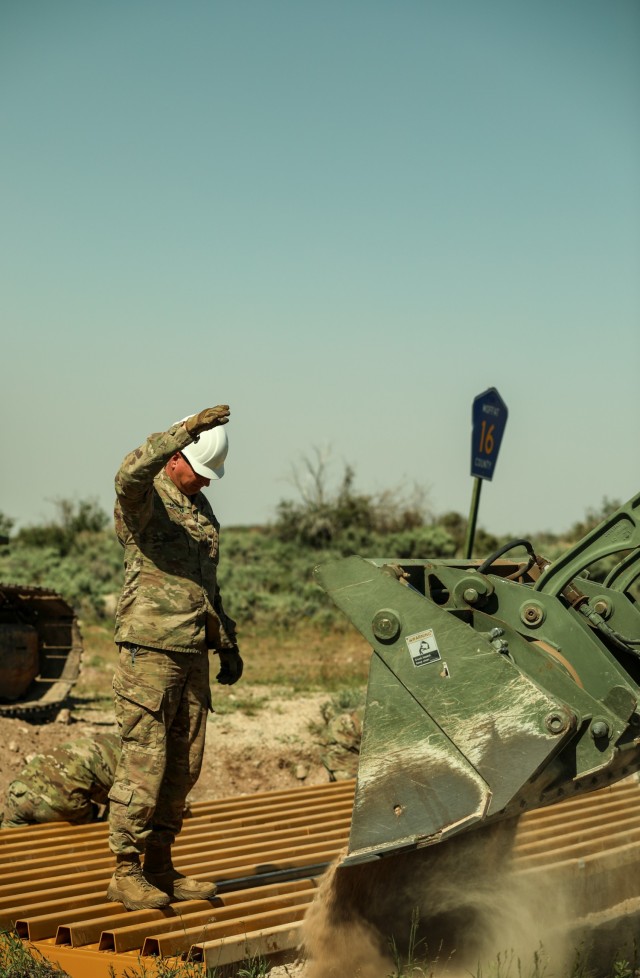 Utah National Guard engineer guides a front loader during training at Dinosaur National Monument in June 2022