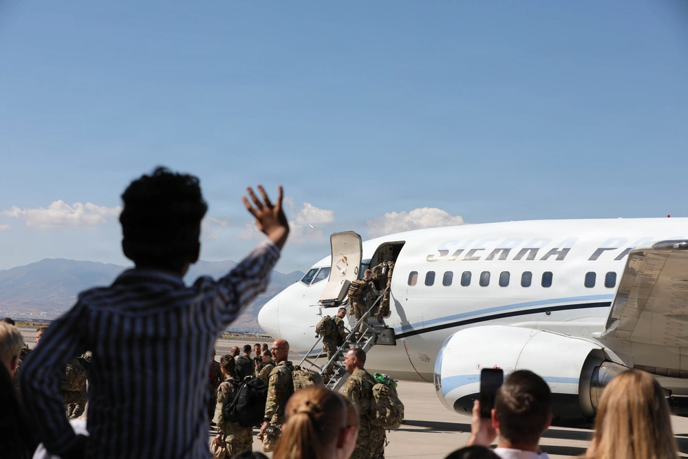 Families waving to departing Utah 144th Medical Company Soldiers at Roland R. Wright Air Base